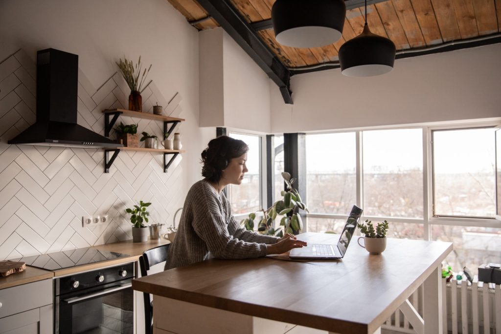 woman in kitchen working on laptop