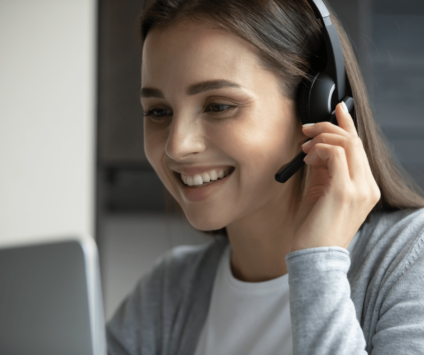 Young woman speaking into headset smiling