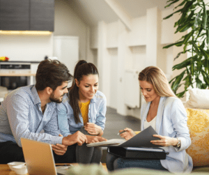 Real estate agent looking over documents with couple