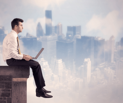 Businessman sitting on side of building above the city graphic
