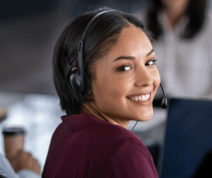 Businesswoman wearing headset smiling at camera