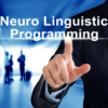 Businessman pointing at Neuro Linguistic Programming graphic